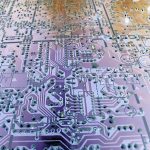 Electronic circuit layout on purple color board close-up full frame image